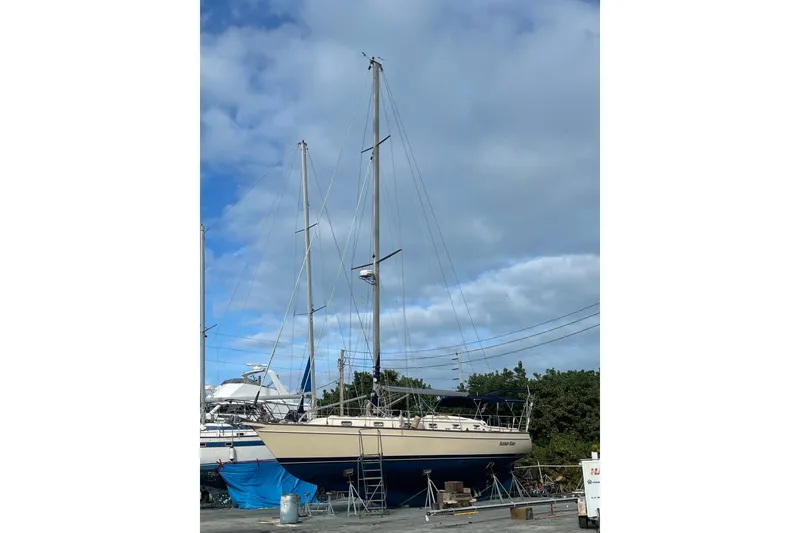 Slide: The Image of 2006 Island Packet 440 sailboat on land, under a cloudy sky. - 54