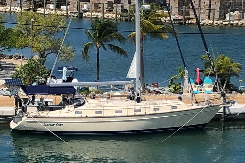 The Image of 2006 Island Packet 440 sailboat docked by tropical waterfront. - 0