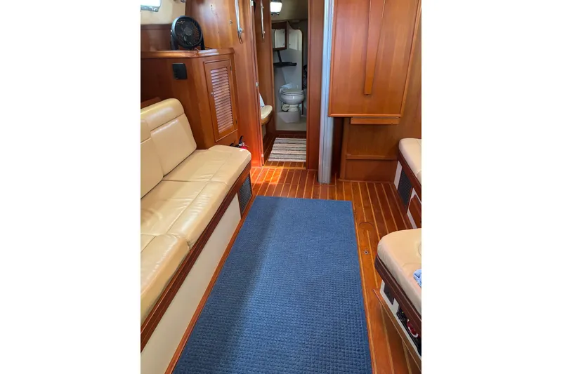 Slide: The Image of Interior of 2006 Island Packet 440 yacht with wooden flooring and beige seating. - 75