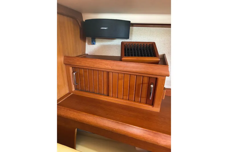 Slide: The Image of Wooden cabinet and Bose speaker inside 2006 Island Packet 440 yacht interior. - 15