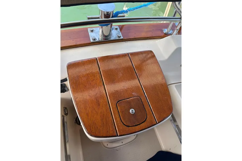 Slide: The Image of Polished wooden helm seat on 2006 Island Packet 440 sailboat. - 32