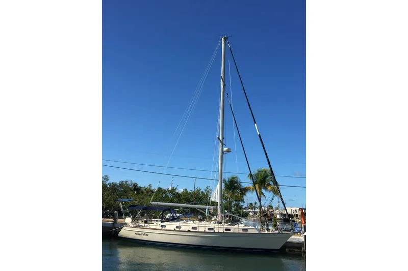 Slide: The Image of 2006 Island Packet 440 sailboat docked under clear blue sky. - 51