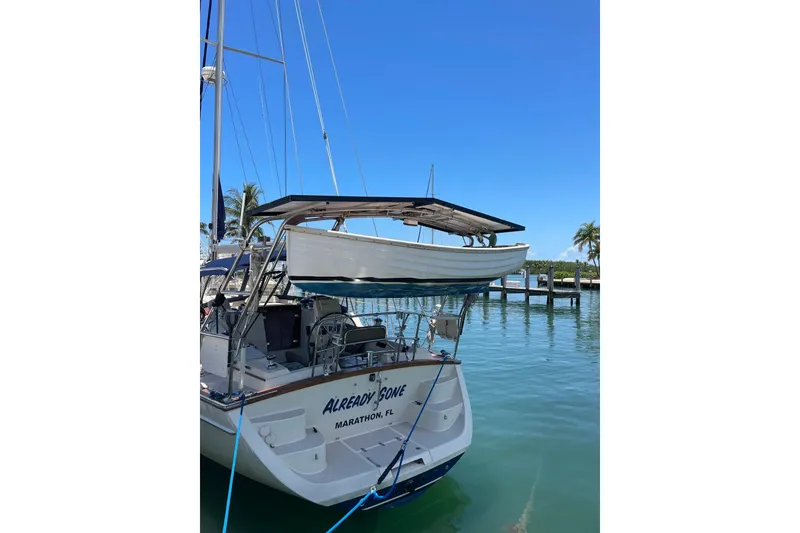 Slide: The Image of Island Packet 440 sailboat docked in Marathon, FL, with a dinghy on davits. - 35