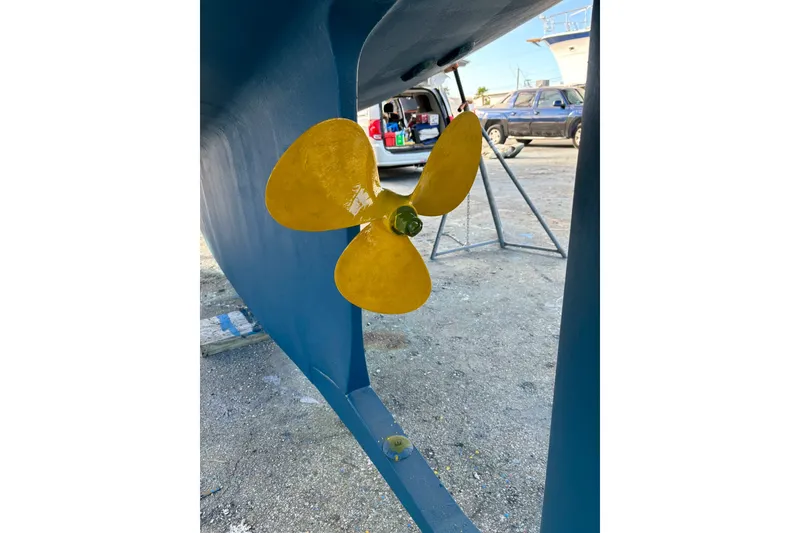 Slide: The Image of Yellow propeller on 2006 Island Packet 440 sailboat, displayed on a boatyard. - 63