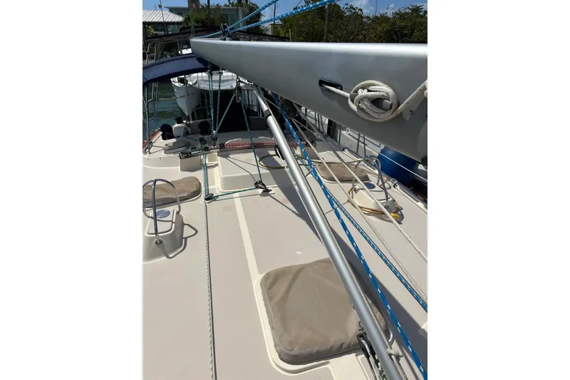 Slide: The Image of 2006 Island Packet 440 sailboat deck with rigging and ropes in marina setting. - 41