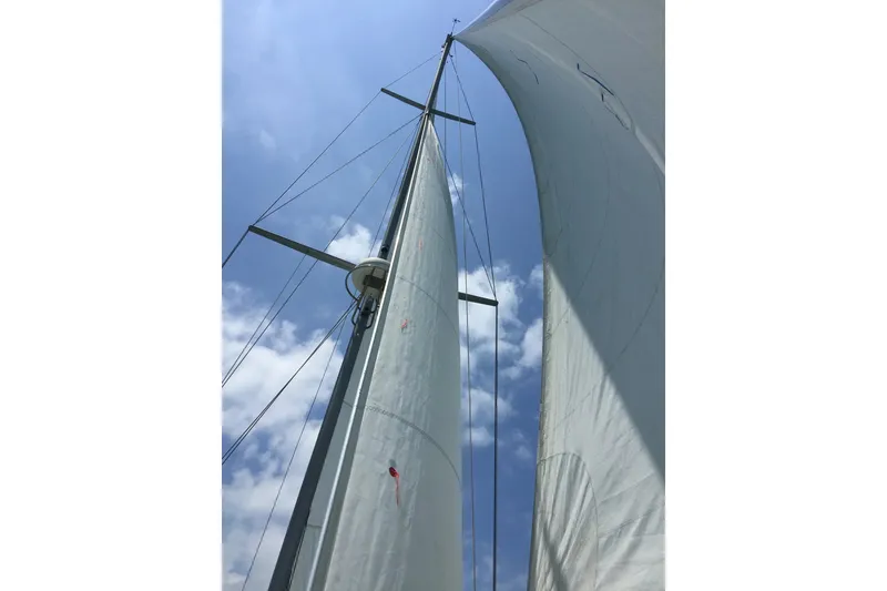 Slide: The Image of Sails of a 2006 Island Packet 440 yacht against a blue sky. - 29