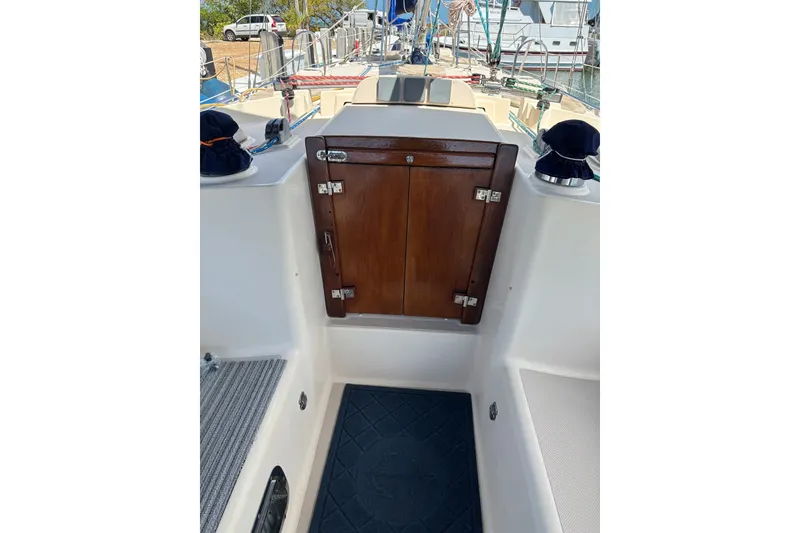 Slide: The Image of 2006 Island Packet 440 sailboat cockpit with wooden hatch and nautical equipment. - 18