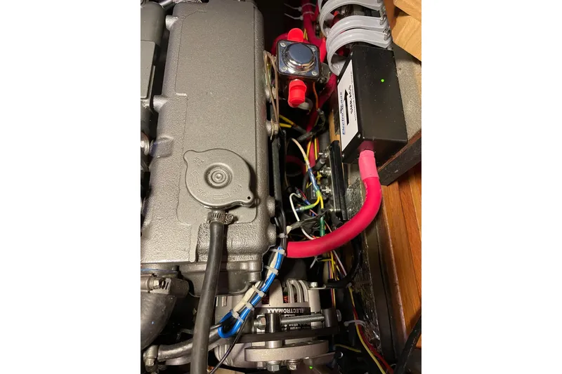 Slide: The Image of Engine compartment of a 2006 Island Packet 440 sailboat, showcasing wiring and components. - 24