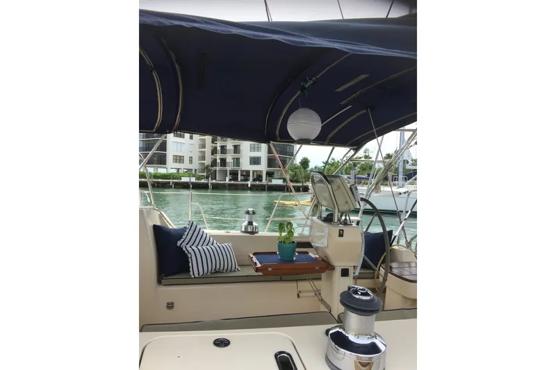 Slide: The Image of Cozy cockpit of 2006 Island Packet 440 sailboat with cushions and potted plant. - 46