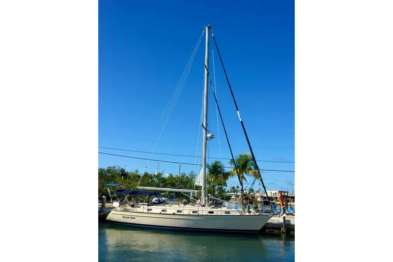Slide: The Image of 2006 Island Packet 440 sailboat docked under clear blue sky. - 52