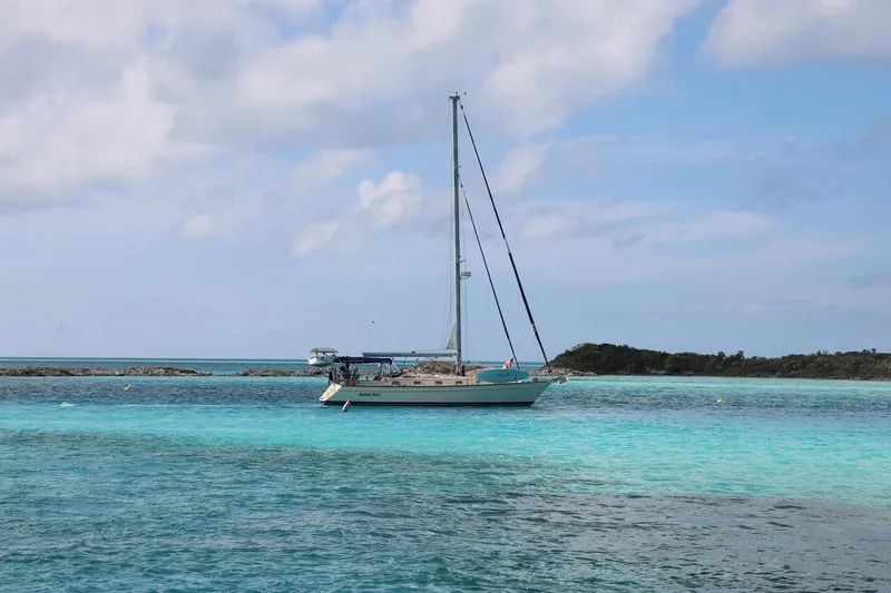 Slide: The Image of Sailboat Island Packet 440 (2006) anchored in clear turquoise waters under a blue sky. - 53