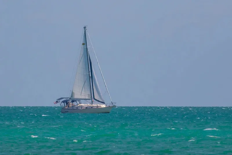 Slide: The Image of Sailing yacht Island Packet 440, 2006 model, cruising on turquoise ocean waters. - 45