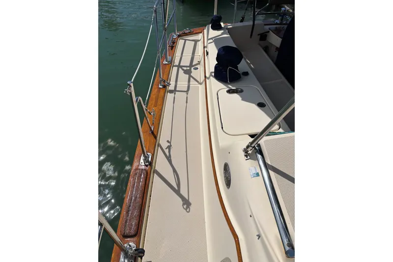 Slide: The Image of 2006 Island Packet 440 sailboat deck with polished wood and stainless steel railings. - 42