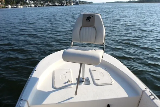 Slide: The Image of 2019 Carolina Skiff 17 JV CC boat with a single seat on calm waters. - 5