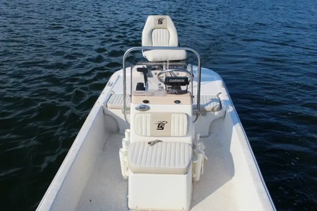 Slide: The Image of 2019 Carolina Skiff 17 JV CC boat on water, featuring center console and seating. - 6
