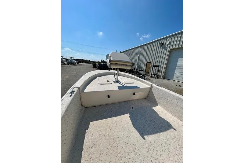 Slide: The Image of 2019 Carolina Skiff 17 JV CC boat, docked outdoors under clear blue sky. - 16