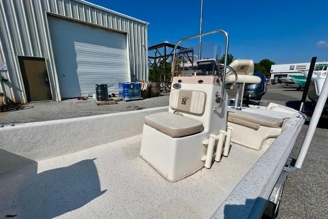 Slide: The Image of 2019 Carolina Skiff 17 JV CC boat with center console, parked outdoors. - 15