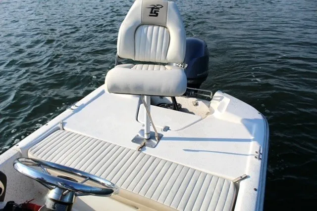 Slide: The Image of 2019 Carolina Skiff 17 JV CC boat with white seating on calm water. - 7