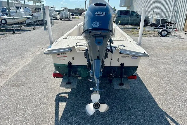 Slide: The Image of 2019 Carolina Skiff 17 JV CC boat with 40 HP outboard motor, parked outdoors. - 10