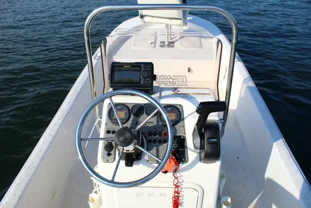 Slide: The Image of 2019 Carolina Skiff 17 JV CC boat console with steering wheel and navigation equipment. - 4