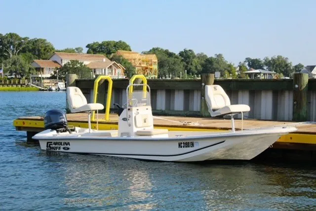 The Image of 2019 Carolina Skiff 17 JV CC boat docked by a waterfront property. - 0