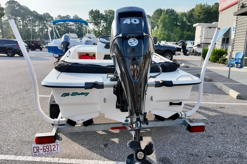 Slide: The Image of 2023 Mako Pro Skiff 13 CC boat with 40 HP motor in parking lot. - 3