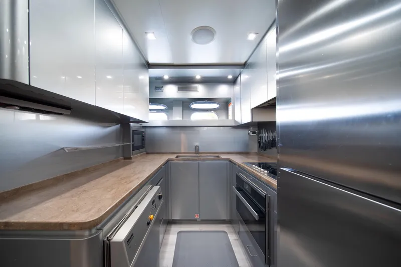 Slide: The Image of Modern kitchen interior on 2008 Arno Leopard 31 yacht, featuring sleek cabinetry and stainless steel appliances. - 59