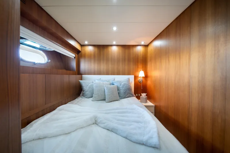Slide: The Image of Luxurious cabin interior of 2008 Arno Leopard 31 yacht with cozy bedding and wooden paneling. - 50