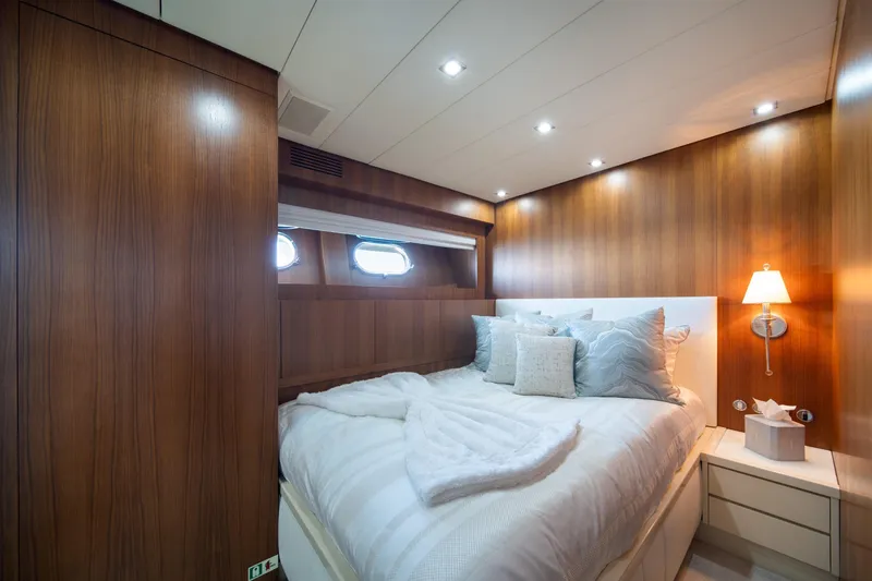 Slide: The Image of Luxurious bedroom interior on 2008 Arno Leopard 31 yacht, featuring wood paneling and cozy bedding. - 49