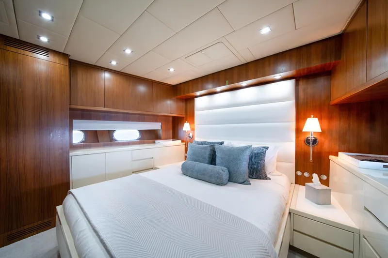 Slide: The Image of Luxurious bedroom interior on 2008 Arno Leopard 31 yacht, featuring elegant wood paneling and modern lighting. - 44