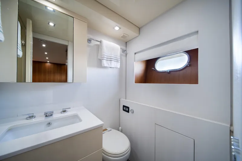Slide: The Image of Luxurious yacht bathroom with modern fixtures, mirror, and porthole window on Arno Leopard 31, 2008. - 52