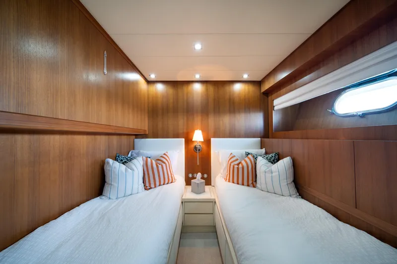 Slide: The Image of Luxurious twin cabin interior on 2008 Arno Leopard 31 yacht with wood paneling and cozy bedding. - 54