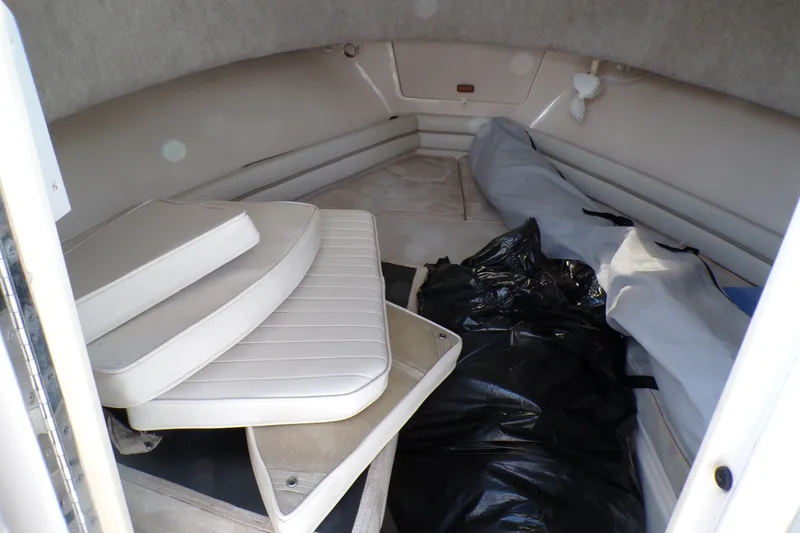 Slide: The Image of 2005 Grady-White Seafarer 226 cabin interior with cushions and storage items. - 17