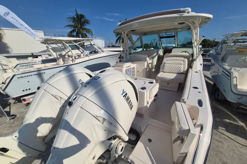 Slide: The Image of 2027 Grady-White Freedom 325 boat with Yamaha engines, docked under clear blue sky. - 18