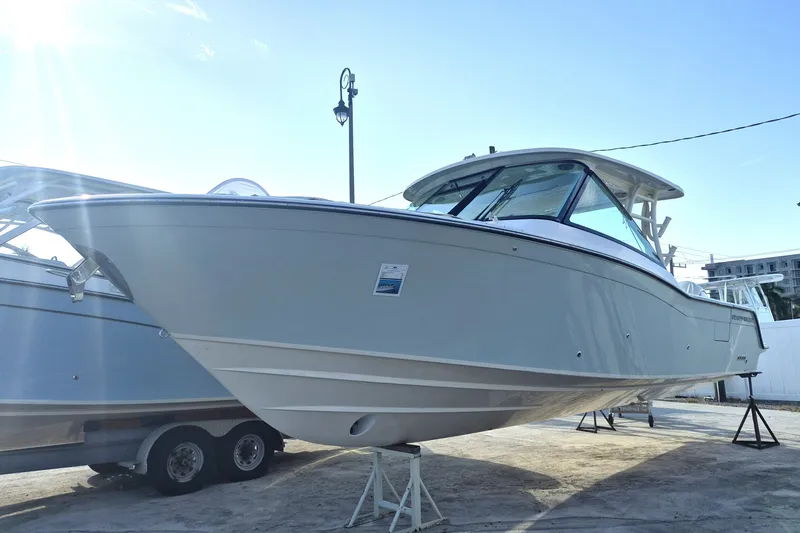 The Image of 2027 Grady-White Freedom 325 boat on display, side view under bright sunlight. - 1