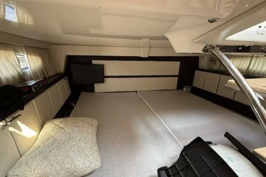 Slide: The Image of Interior cabin of 2015 Regal 32 Express boat, featuring spacious sleeping area and modern design. - 35