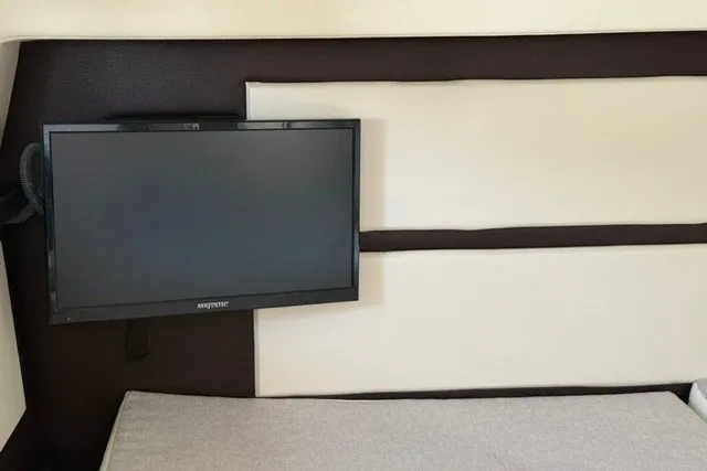 Slide: The Image of Interior of 2015 Regal 32 Express boat with mounted TV screen. - 21