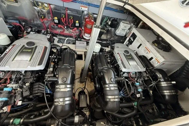 Slide: The Image of Engine compartment of a 2015 Regal 32 Express boat, featuring dual engines and wiring. - 14