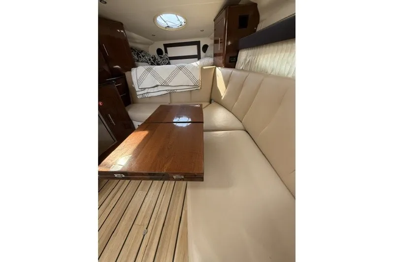 Slide: The Image of Interior of 2015 Regal 32 Express yacht with beige seating and wooden table. - 40