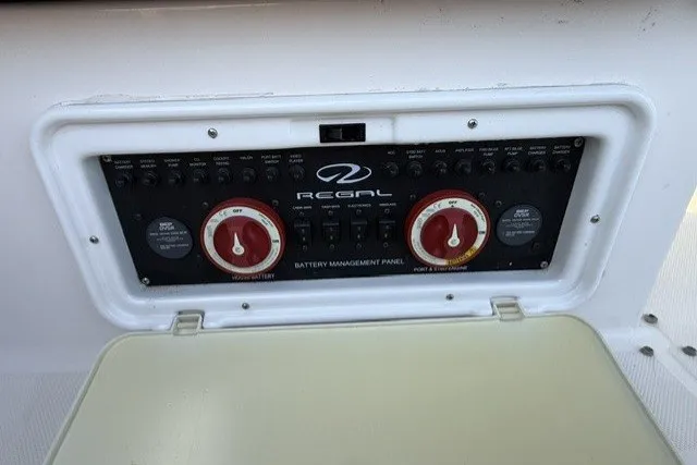 Slide: The Image of Battery management panel on 2015 Regal 32 Express boat, featuring control dials and switches. - 31