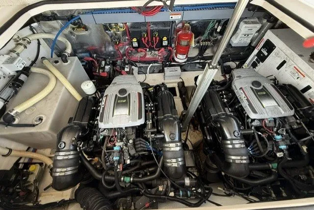 Slide: The Image of Engine compartment of a 2015 Regal 32 Express boat, featuring dual engines and equipment. - 15