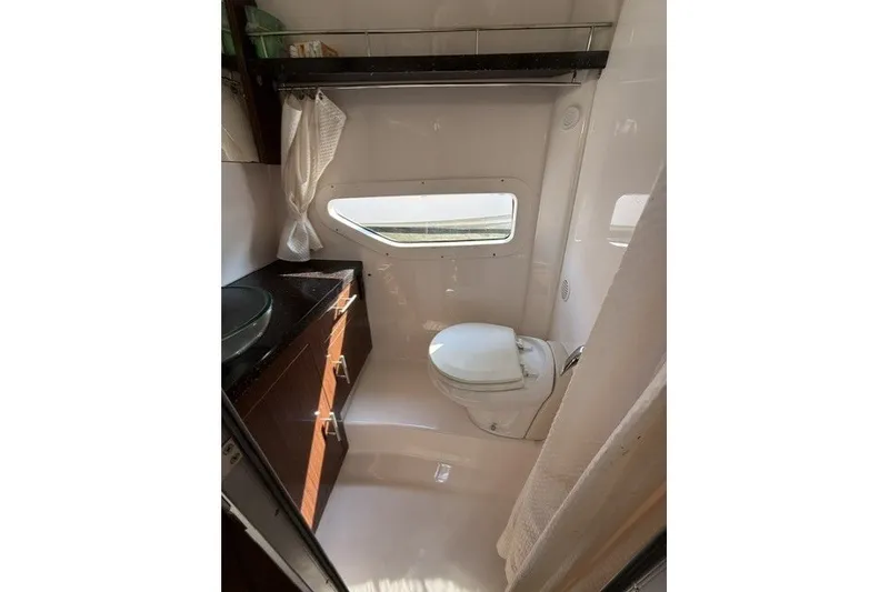Slide: The Image of Bathroom interior of 2015 Regal 32 Express yacht with toilet and sink. - 26