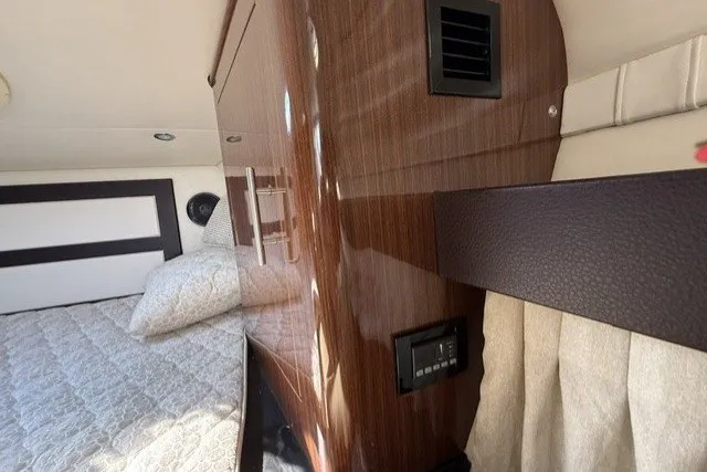 Slide: The Image of Interior cabin of 2015 Regal 32 Express yacht with wood paneling and bedding. - 25
