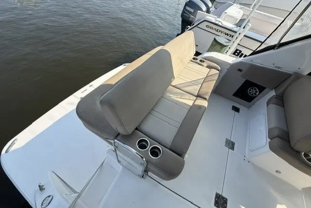 Slide: The Image of 2015 Regal 32 Express boat with beige seating and cup holders on deck. - 33