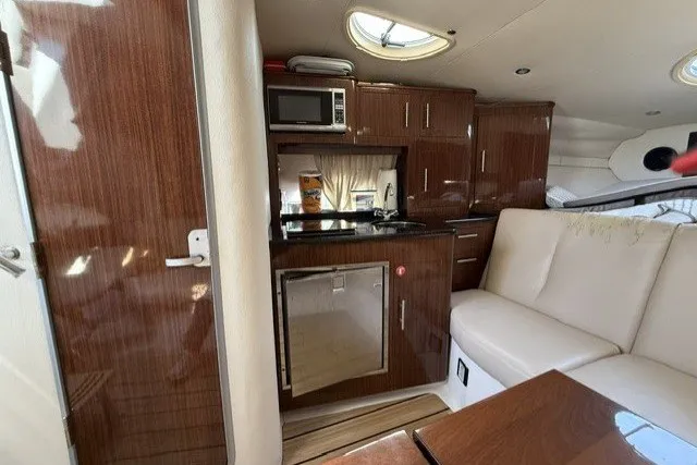 Slide: The Image of Luxurious interior of a 2015 Regal 32 Express yacht with kitchenette and seating area. - 29