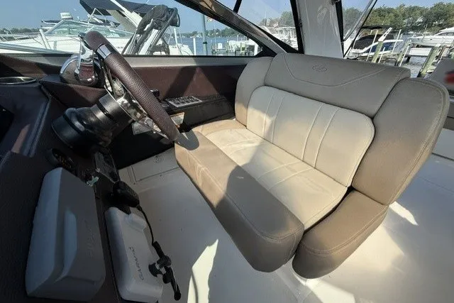 Slide: The Image of 2015 Regal 32 Express boat interior with beige seating and steering wheel. - 23