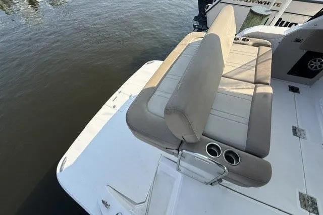 Slide: The Image of 2015 Regal 32 Express boat with beige seating and cup holders on deck. - 27