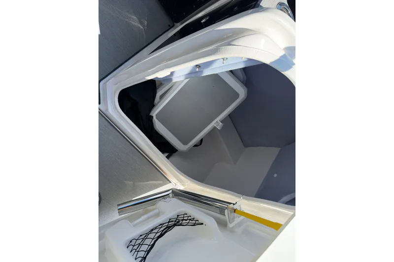 Slide: The Image of 2024 Yamaha Boats AR250 storage compartment with netting and interior view. - 14