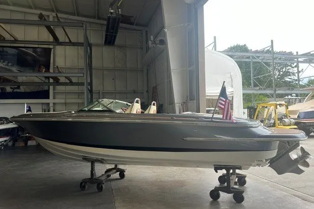 Slide: The Image of 2019 Chris-Craft Launch 23 boat in a storage facility, featuring sleek design and American flag. - 7