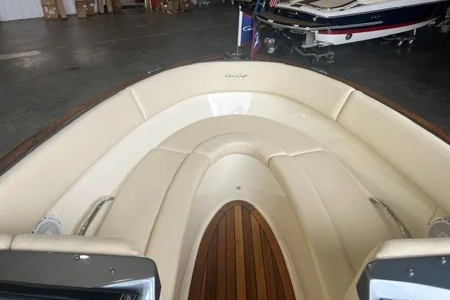 Slide: The Image of 2019 Chris-Craft Launch 23 boat interior with cream seating and wooden flooring. - 11